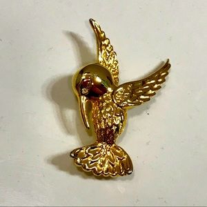 Vintage gold tone bird pin with crystal eye